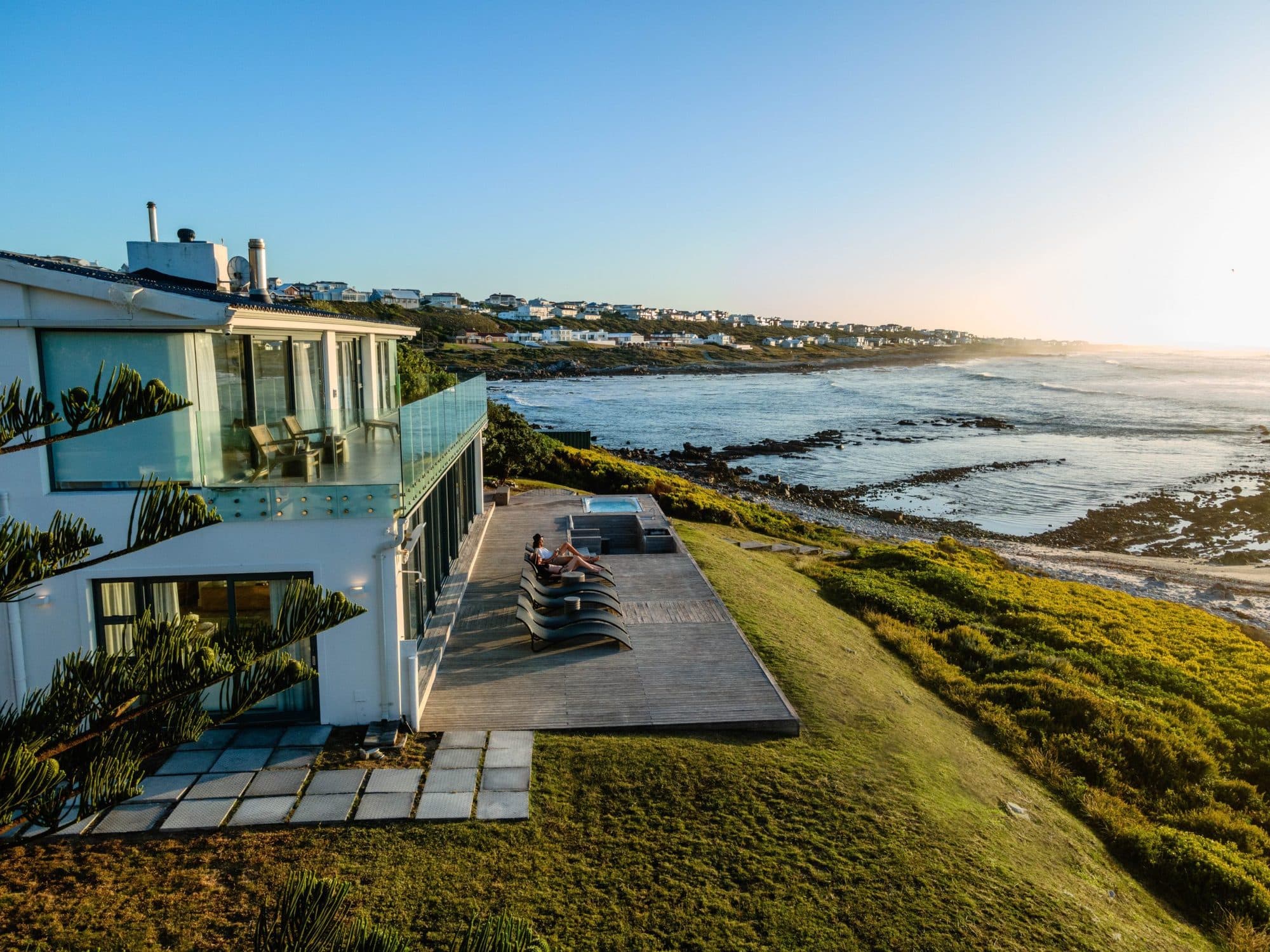 Golden-hour aerial view of Marlin Manor's jacuzzi deck and private beach at L'Agulhas