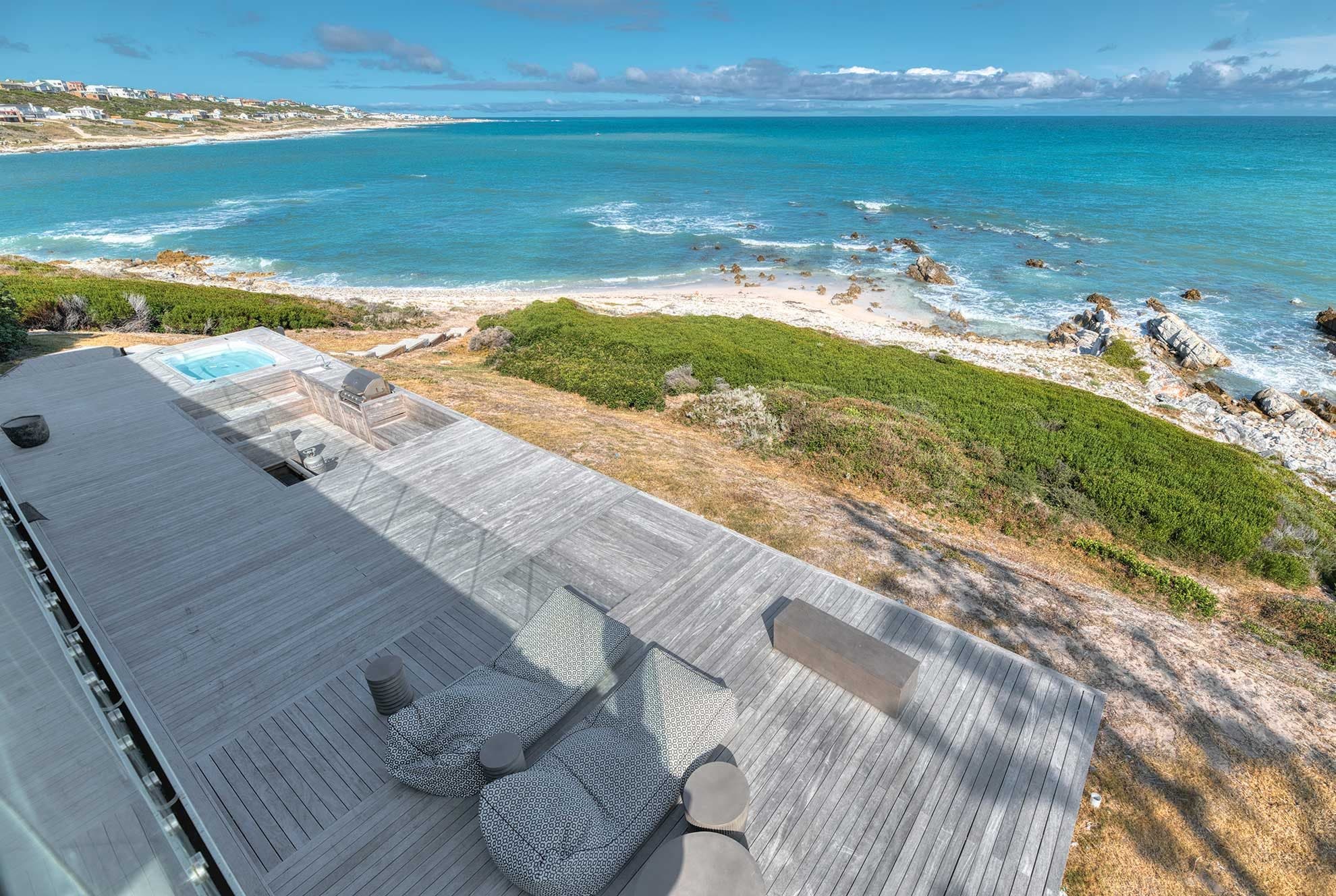 Aerial view of Marlin Manor's jacuzzi deck stepping straight down onto its own private beach